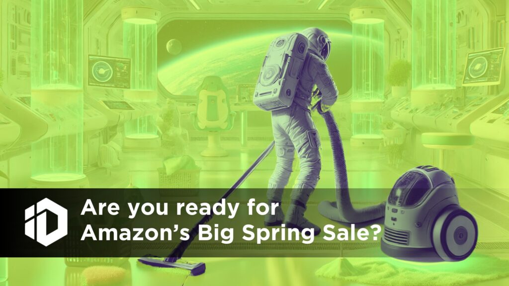A futuristic astronaut in a high-tech space station is vacuuming the floor with a robotic vacuum cleaner nearby. The scene is bathed in a neon green overlay. A bold black banner with white text reads, "Are you ready for Amazon’s Big Spring Sale?" on the lower section of the image, accompanied by a geometric logo on the left. The background features a sleek, advanced space station with glowing blue-green cylindrical structures, floating shelves, and a view of a planet through the window.